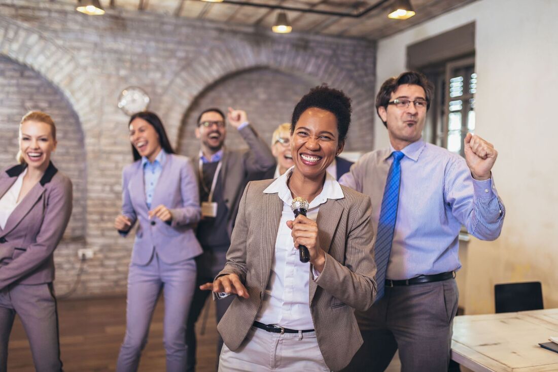 Business people dancing and singing with microphone having fun Picture