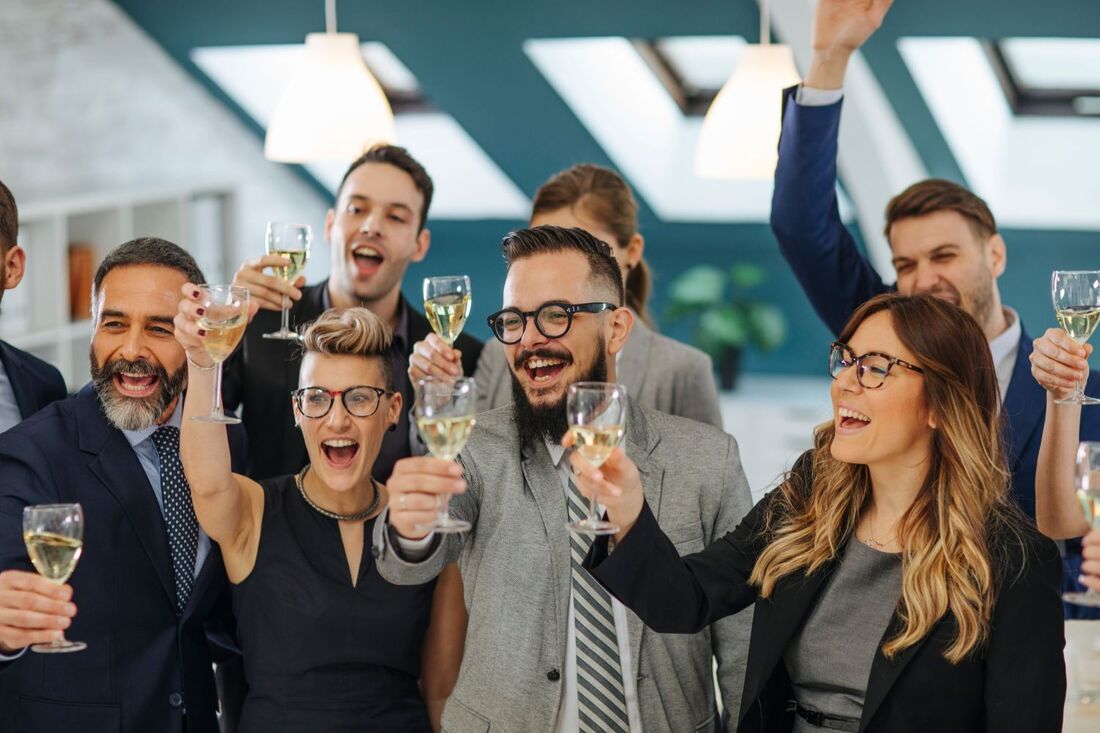 Joyful business people raising glasses in a toast with big smiles Picture