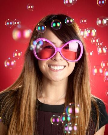Woman with big funny pink glasses with bubbles floating Picture