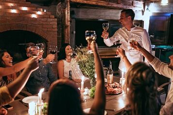 Chef toasting large group at dinner table in fine dining restaurant Picture