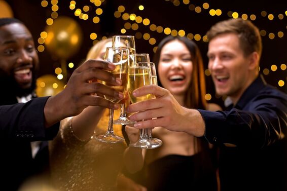 4 people toasting with champagne big smiles on New Years Picture