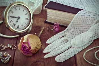 Memory table with books, jewelry, lace gloves, dried rose, old time clock Picture
