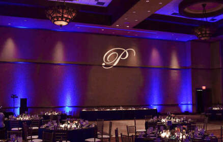 Ultraviolet uplights shining on wall with monogram P spotlight Picture