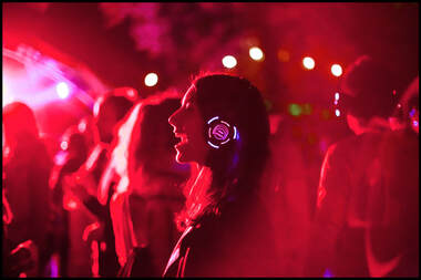 Silent Disco red lighting and led headphones dancing smiling Picture