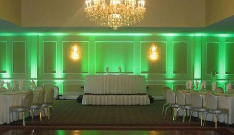Emerald green uplights at wedding banquet room with chandelier Picture