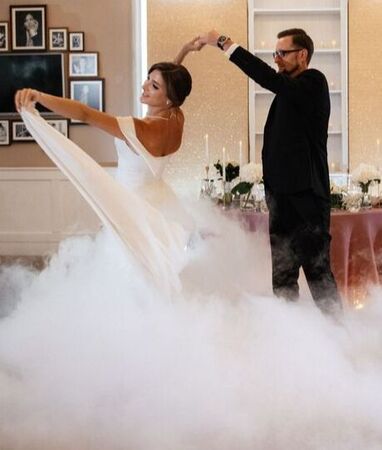 Elegant bride and groom dancing with smoke or fog machine cloudsPicture