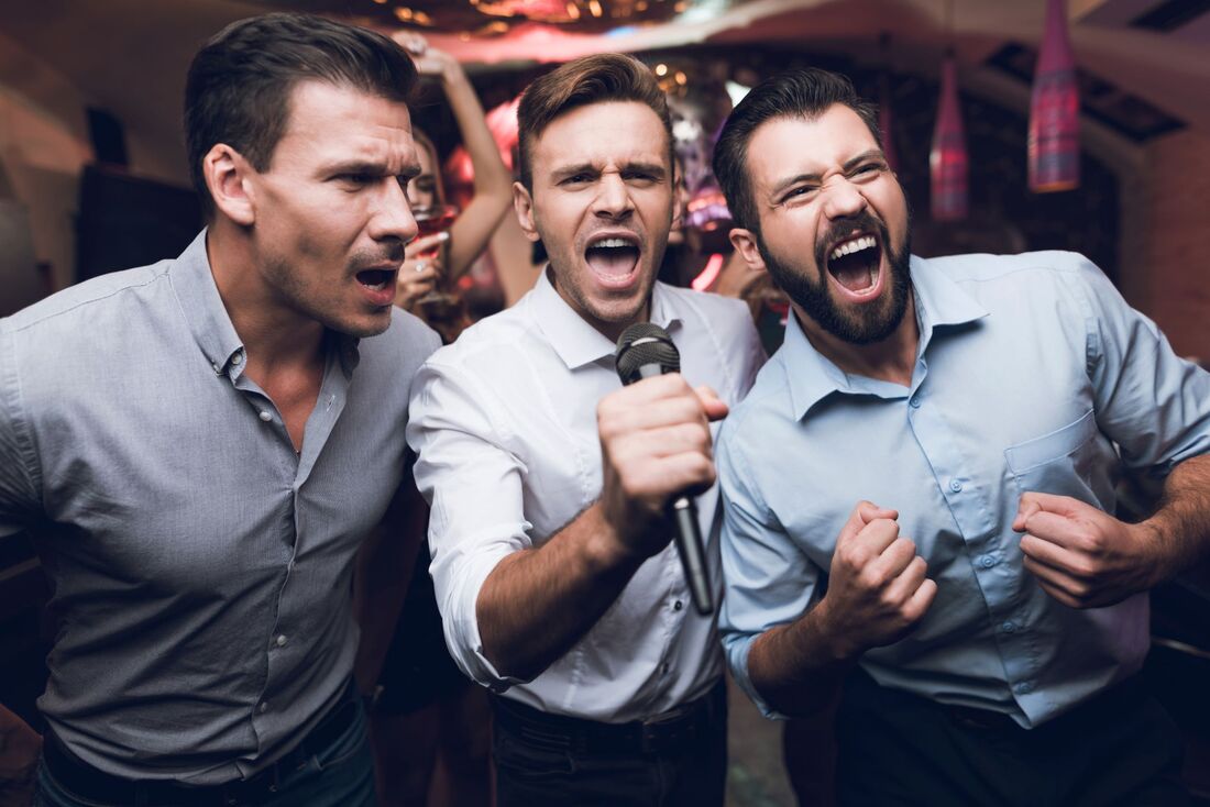 3 men singing karaoke with gusto Picture